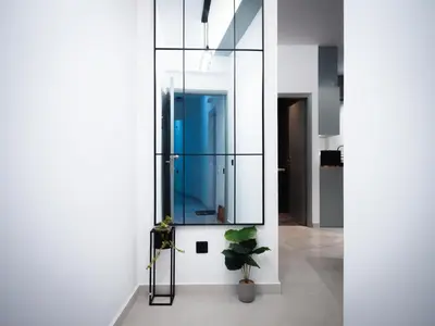 a room with a mirror and a potted plant at Sea Side Apartment Rhodes City Center in Rhodes Town
