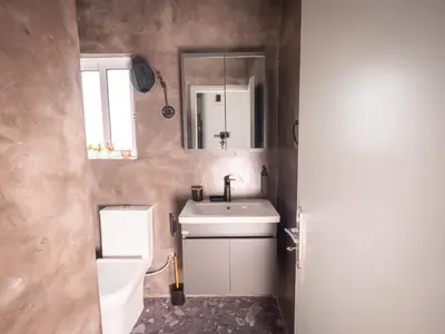 a bathroom with a sink and a toilet and a mirror at Sea Side Apartment Rhodes City Center in Rhodes Town