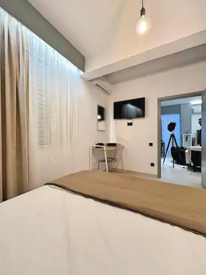 a bedroom with a large bed with a large window at Sea Side Apartment Rhodes City Center in Rhodes Town
