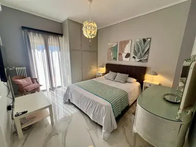 a bedroom with a bed and a table and a mirror at Paradise City Apartment 2 in Rhodes Town