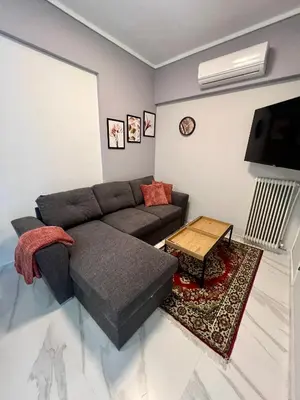 a living room with a couch and a table at Paradise City Apartment 2 in Rhodes Town