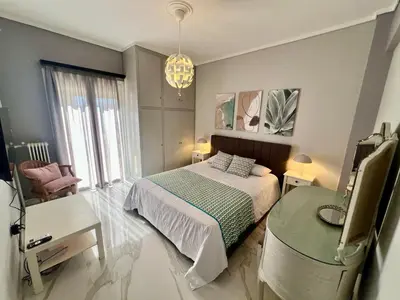 a bedroom with a bed and a table and a chair at Paradise City Apartment 2 in Rhodes Town