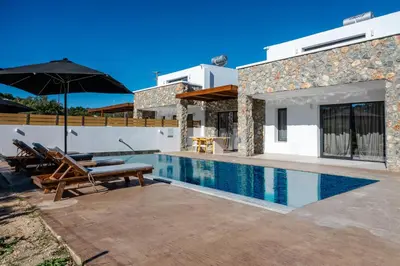 a villa with a swimming pool and a house at Brillante VIllas by Renthub in Kolimbia