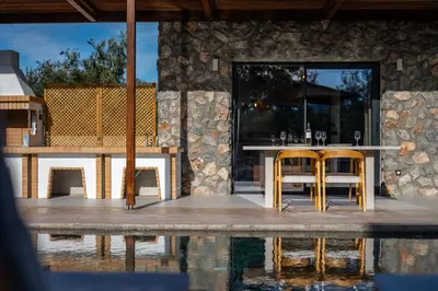 a patio with a table and chairs next to the water at Brillante VIllas by Renthub in Kolimbia