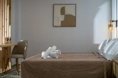 a teddy bear sitting on top of a bed at Nouvelle15 Cozy House with Private Pool in Koskinou