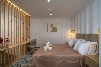 a bedroom with a bed with a teddy bear on it at Nouvelle15 Cozy House with Private Pool in Koskinou