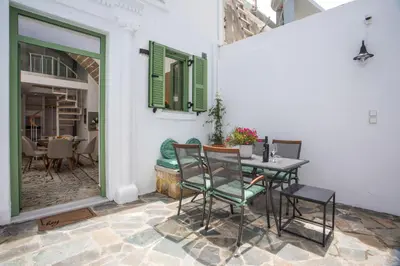 a patio with a table and chairs on a patio at Nouvelle15 Cozy House with Private Pool in Koskinou