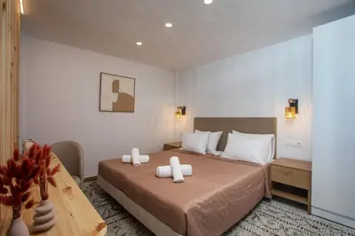 a bedroom with a bed with two towels on it at Nouvelle15 Cozy House with Private Pool in Koskinou