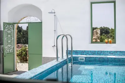a swimming pool in a house with an open door at Nouvelle15 Cozy House with Private Pool in Koskinou