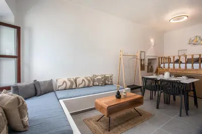 a living room with a couch and a table at Port Elegance Residence - Halki in Halki