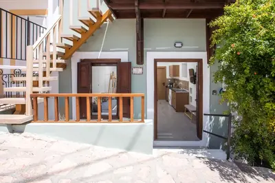 a house with a staircase leading to a kitchen at Port Elegance Residence - Halki in Halki