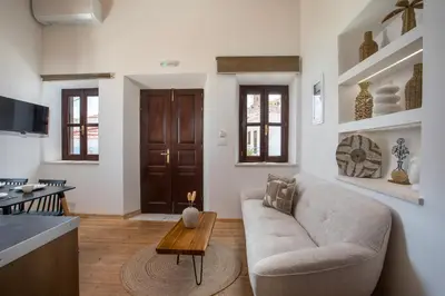 a living room with a couch and a table at Port Elegance Residence - Halki in Halki
