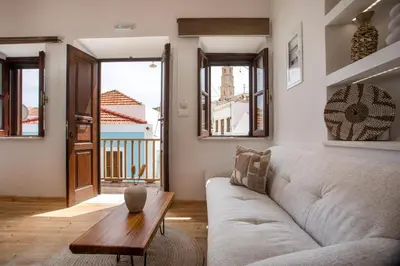 a living room with a couch and a table at Port Elegance Residence - Halki in Halki
