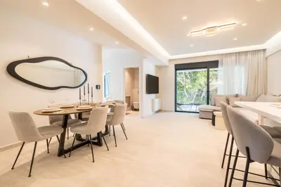a dining room with a mirror and a table and chairs at D&R Boutique Apartments Central in Rhodes Town