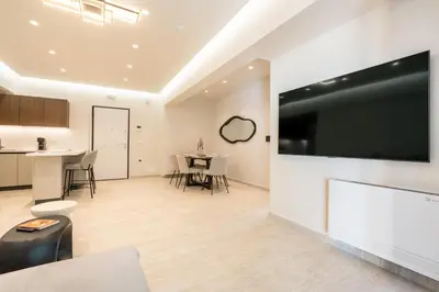 a living room with a large flat screen tv on the wall at D&R Boutique Apartments Central in Rhodes Town
