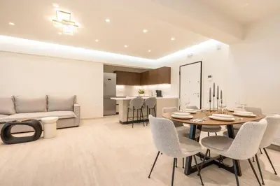 a living room with a table and chairs and a couch at D&R Boutique Apartments Central in Rhodes Town