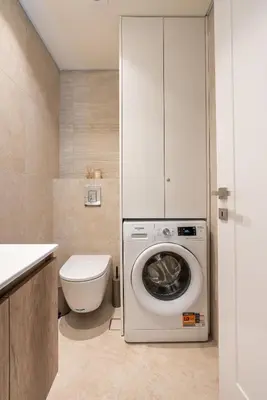 a bathroom with a washing machine and a toilet at D&R Boutique Apartments Central in Rhodes Town