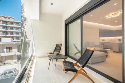 a balcony with two chairs and a living room at D&R Boutique Apartments Central in Rhodes Town
