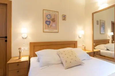 a bedroom with a white bed and a mirror at Rodos Aqua Luxury Villa in Rhodes Town