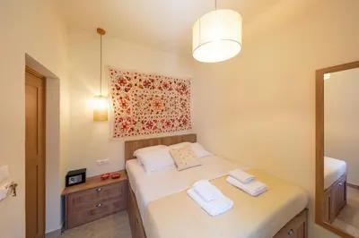 a bedroom with a bed with two towels on it at Rodos Aqua Luxury Villa in Rhodes Town