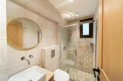 a bathroom with a toilet and a sink and a shower at Rodos Aqua Luxury Villa in Rhodes Town