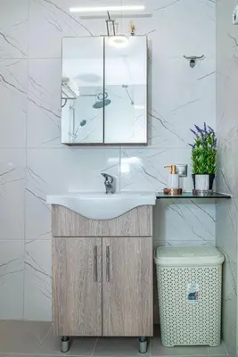 a bathroom with a sink and a mirror at Avli Village House with Private Jacuzzi in Paradeísion