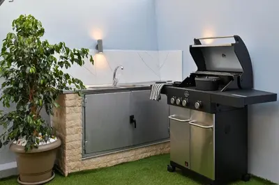 a kitchen with a stove and a sink and a plant at Avli Village House with Private Jacuzzi in Paradeísion