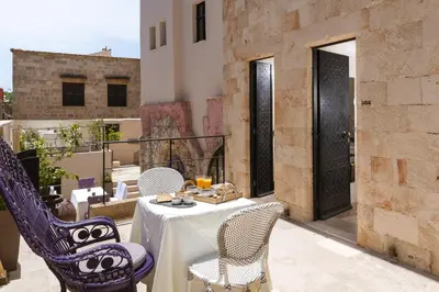 a patio with a table and chairs on a balcony at Allegory Boutique Hotel in Rhodes Town