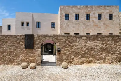 a stone building with a door and two buildings at Allegory Boutique Hotel in Rhodes Town