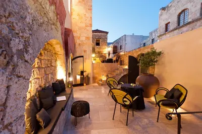 a patio with chairs and tables in a building at Allegory Boutique Hotel in Rhodes Town