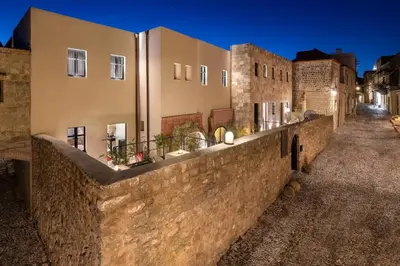 a stone wall in front of a building at Allegory Boutique Hotel in Rhodes Town
