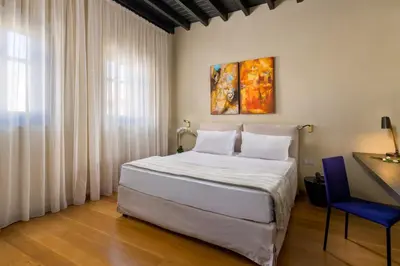 a bedroom with a bed and a desk and a window at Allegory Boutique Hotel in Rhodes Town