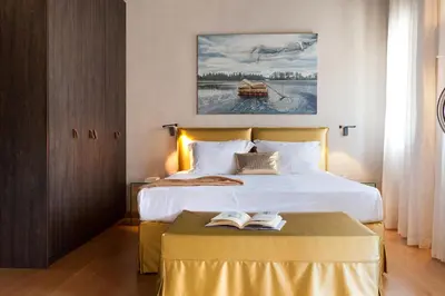 a bedroom with a bed and a table with books on it at Allegory Boutique Hotel in Rhodes Town