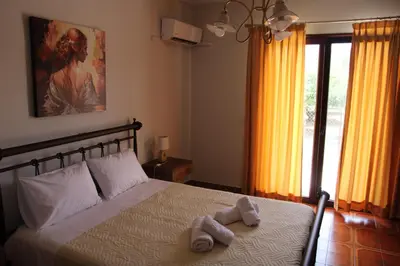 a bedroom with a bed with two towels on it at Despinas Village House in Kalavárda