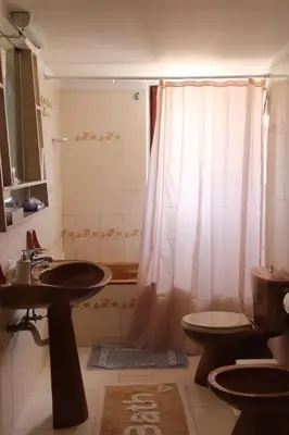 a bathroom with a sink and a toilet and a shower at Despinas Village House in Kalavárda