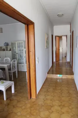 an open door to a living room with a table at Despinas Village House in Kalavárda