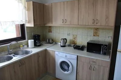 a kitchen with a washing machine and a sink at Despinas Village House in Kalavárda