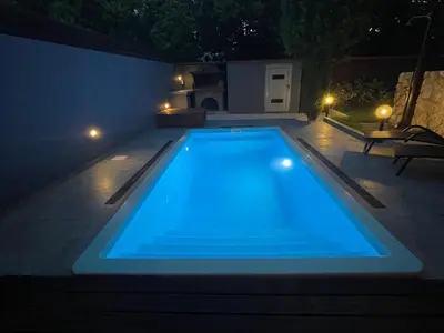 a swimming pool in a backyard at night at Casa del Emma in Koskinou in Koskinou