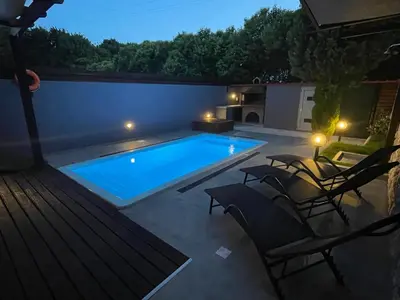 a swimming pool in a backyard at night at Casa del Emma in Koskinou in Koskinou