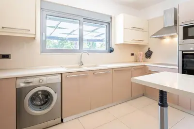 a kitchen with a washing machine and a window at Casa del Emma in Koskinou in Koskinou