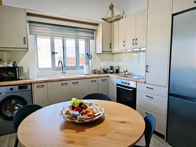 a kitchen with a table with a bowl of fruit on it at Mandilaria stone house in Afantou