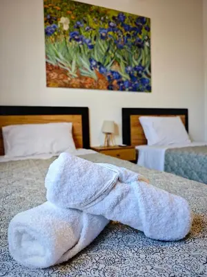 a white towel laying on top of a bed at Mandilaria stone house in Afantou