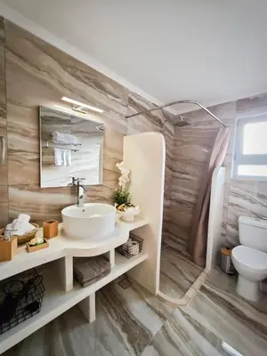 a bathroom with a sink and a toilet at Mandilaria stone house in Afantou