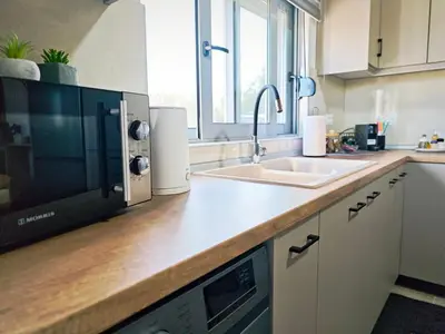 a kitchen with a sink and a microwave at Mandilaria stone house in Afantou