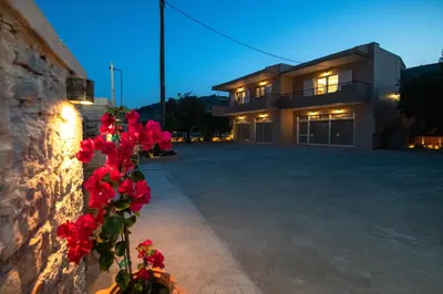 a house with red flowers in front of it at Casa Serena in Lardos