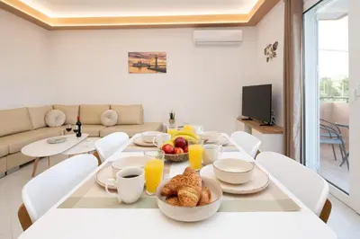 a dining room with a table with food on it at Casa Serena in Lardos