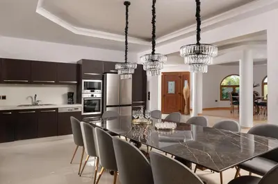 a kitchen and dining room with a table and chairs at Vento Estivo Mansion in Pastida