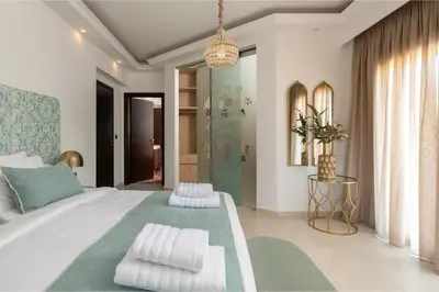a bedroom with a large bed with two pillows at Vento Estivo Mansion in Pastida