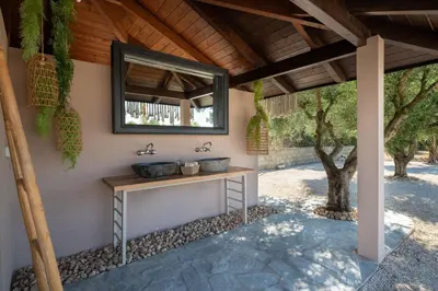 a bathroom with two sinks and a mirror at Vento Estivo Mansion in Pastida