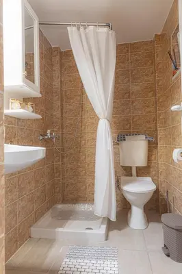 a bathroom with a shower with a toilet and a sink at Barbara's Apartments in Vrachonisída touArchangélou